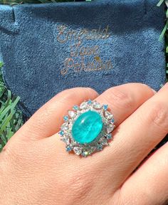 4 Cabochon PARAIBA Blue Halo Vintage Style Ring, Magnificent Vivid Ocean Blue Statement Ring For Her Adjustable Size 6-8 w 18KGP Mainstone size is 8x10mm 4 Carat Overall size is 22x22mm ♥Ready to ship ♥ The main stone is the Finest Doublet PARAIBA TOURMALINE. ♥Absolutely gorgeous and beautifully handcrafted Finest Doublet PARAIBA TOURMALINE in an exquisite setting. ♥ This classic yet trendy Jewelry makes the perfect Christmas/Anniversary/Valentine's/Birthday gift for her that will be treasured f Blue Emerald Rings With Halo Setting, Blue Emerald Jewelry For Formal Occasions, Blue Cabochon Ring For Wedding, Blue Emerald Ring With Halo Setting, Blue Emerald Halo Setting Ring, Blue Cabochon Wedding Ring, Formal Blue Emerald Ring With Halo Setting, Formal Blue Emerald Jewelry, Formal Blue Emerald Ring With Accent Stones