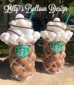 two starbucks coffee cups filled with white and brown balloons