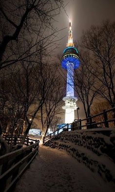 the tower is lit up in blue and white