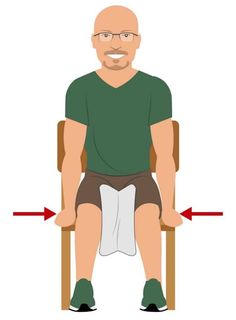 a man sitting in a chair with his legs crossed