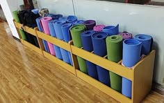 there are many different colored yoga mats in the holder