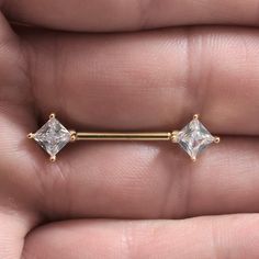 a pair of gold nose studs with clear stones