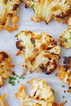 roasted cauliflower florets with parsley on the top and green sprouts in the middle