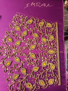 an intricately designed purple and gold paper