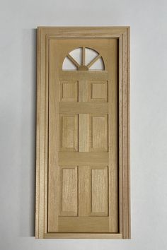 a wooden door with an arched top and side panels on the bottom panel is shown