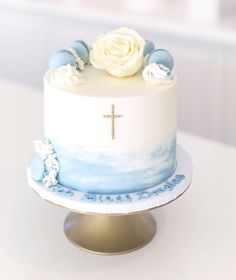 a white and blue cake sitting on top of a table