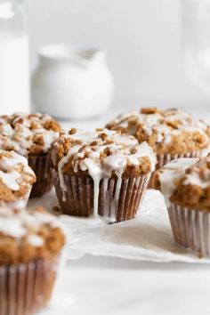 muffins with white icing and crumbs on top