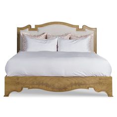 a bed with white sheets and pillows on top of it's headboard, in front of a white background