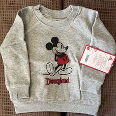 Gray Disneyland Mickey Mouse Sweatshirt For A 12-18 Mos Old. Bought This To Send To My Husband’s Grandnephew For Christmas But Realized He Needed A Larger Size. Purchased From The Shopdisney Website. I’m Not Sure If The Gray One Is Still Available Right Now. Disneyland Mickey Mouse, Disney Sweatshirt, Mickey Mouse Sweatshirt, To My Husband, Disney Shop, Disney Sweatshirts, Disney Shirts, The Gray, My Husband