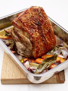 a roasting pan filled with meat and vegetables