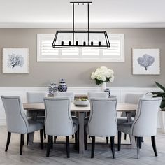 a dining room table with chairs and a chandelier