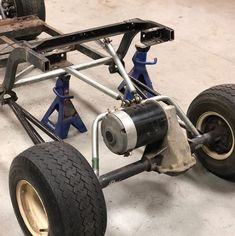 the rear end of a race car being worked on