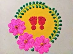 a yellow circle with pink flowers and green leaves on it, surrounded by two pairs of foot prints