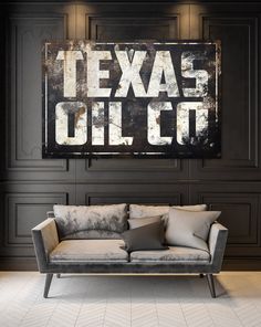 a couch sitting in front of a sign that says texas oil co