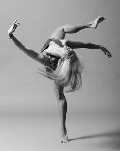 a woman is doing a handstand in the air