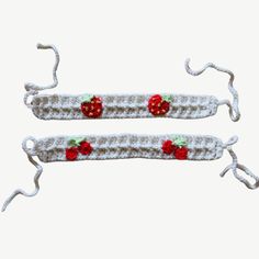 two crocheted hair clips with strawberries on them