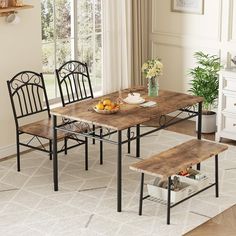 a kitchen table with two chairs and a bowl of fruit