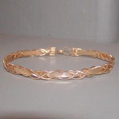 A clever bracelet design that I call the grapevine--this one is four 14kt gold filled square wires overlaid with a 4-strand braid or weave design. A unique, eye-catching look! The built-in hook and eye-type clasp is easy to get on and off. A perfect everyday accessory, sure to get noticed! Choose your size variation for a comfortable custom fit! Add on a jewelry polishing cloth to keep your bracelet--and ALL your jewelry--shiny clean! https://www.etsy.com/listing/732310828/jewelry-polishing-clot Medical Bracelets, Silver Wire Jewelry, Wrapped Bracelets, Wire Wrap Jewelry Designs, Wire Wrapped Bangles, Bracelet Set Silver, Wire Jewelry Tutorial, Gold And Silver Bracelets, Wire Bangles