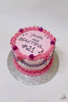 a pink birthday cake with writing on it