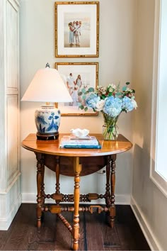 a table with flowers on it and a lamp next to it