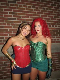 two women dressed up in costumes posing for the camera with one woman wearing green and red