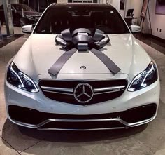 a mercedes car with a bow on the hood