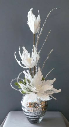 a vase filled with white flowers on top of a table