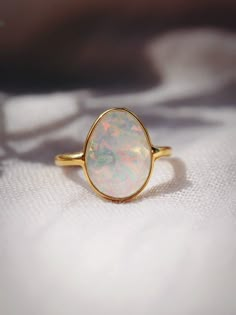 This bold gold statement ring features organic shaped Fire Opal that shines from within. This gorgeous gold ring is sure to become an everyday staple. Wear it solo or stack it with our other favorite rings.✦ DETAILS ✦✧ Name: Hinuhinu (HEE noo HEE noo) - bright, glittering, splendid.✧ Available in whole sizes 5-9. ✧ Synthetic Fire Opal Stone.✧ 18kt Gold Vermeil.✧ All Ke Aloha Jewelry pieces come packaged thoughtfully, beautifully, and ready for gift giving. Modern Opal Ring, Opal Rock, Opal Statement Ring, Gold Moonstone Ring, Rings Sets, Rock Rings, Opal Band, Opal Wedding Rings, Fire Opal Ring