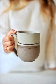 a woman holding a coffee cup in her hands