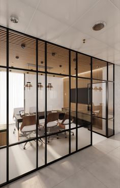 an office with glass walls and wooden accents