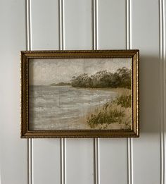 a painting hanging on the wall next to a white paneled wall with vertical stripes