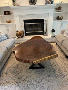 a living room with two couches and a coffee table in front of a fireplace