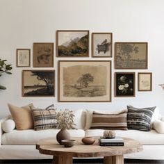 a living room filled with white furniture and pictures on the wall above it's coffee table