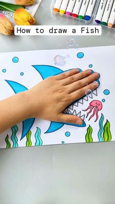 a child's hand on top of a drawing board