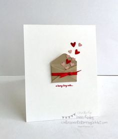 a card with an envelope and hearts on it