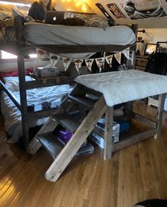 a bunk bed sitting on top of a hard wood floor next to a white chair