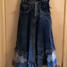 a denim skirt hanging up on a door