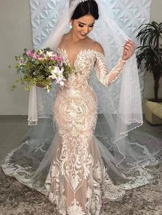 a woman in a wedding dress holding flowers