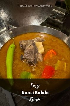 a bowl filled with soup and vegetables on top of a stove