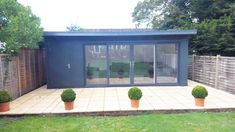 a small garden room with two potted plants