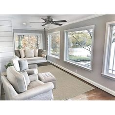 a living room filled with furniture and windows