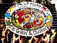 a grill that has some food on it and fire in the background with words chef mate is grilling & chillin