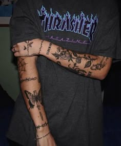 a man with tattoos on his arm and arms