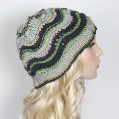 "This is a stylish hat knit in 100% extrafine merino wool in a wavy pattern. This alluring beanie is hand made in the USA using top quality Italian yarn and is ready to be shipped.  All items are made in a smoke-free, pet-free environment. Details: - Knit wavy design beanie hat - Color: Shades of green (as shown) - Size: One size fits 20\"-23\" (50-58 cm) head size - Fiber Content: 100% Extrafine merino wool - Care: Hand wash, dry flat. Please note that while we make every effort to accurately represent the colors of the item. please note that your monitor settings may affect the appearance of these colors on your screen.  Please refer to our store policies for more information on shipping, returns, and international customs duties/fees." Wavy Pattern, Wavy Design, Hat Knit, Stylish Hats, Skull Cap Beanie, Cool Hats, Wool Hat, Winter Hat, Color Shades