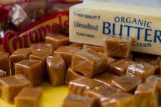 a table topped with lots of pieces of chocolate next to a carton of butter