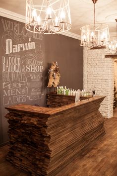 a wooden counter sitting in front of a chalkboard wall