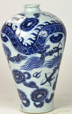 a blue and white vase sitting on top of a table