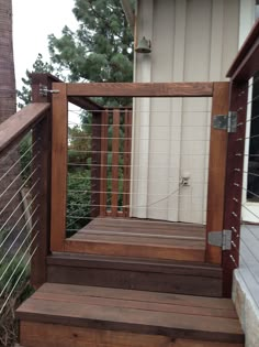 a screen shot of a wooden deck with railings and doors on the bottom level