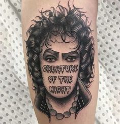 a tattoo with the words creature of the night written on it's face and curly hair