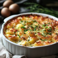 a casserole dish with potatoes and parsley in the center on a table